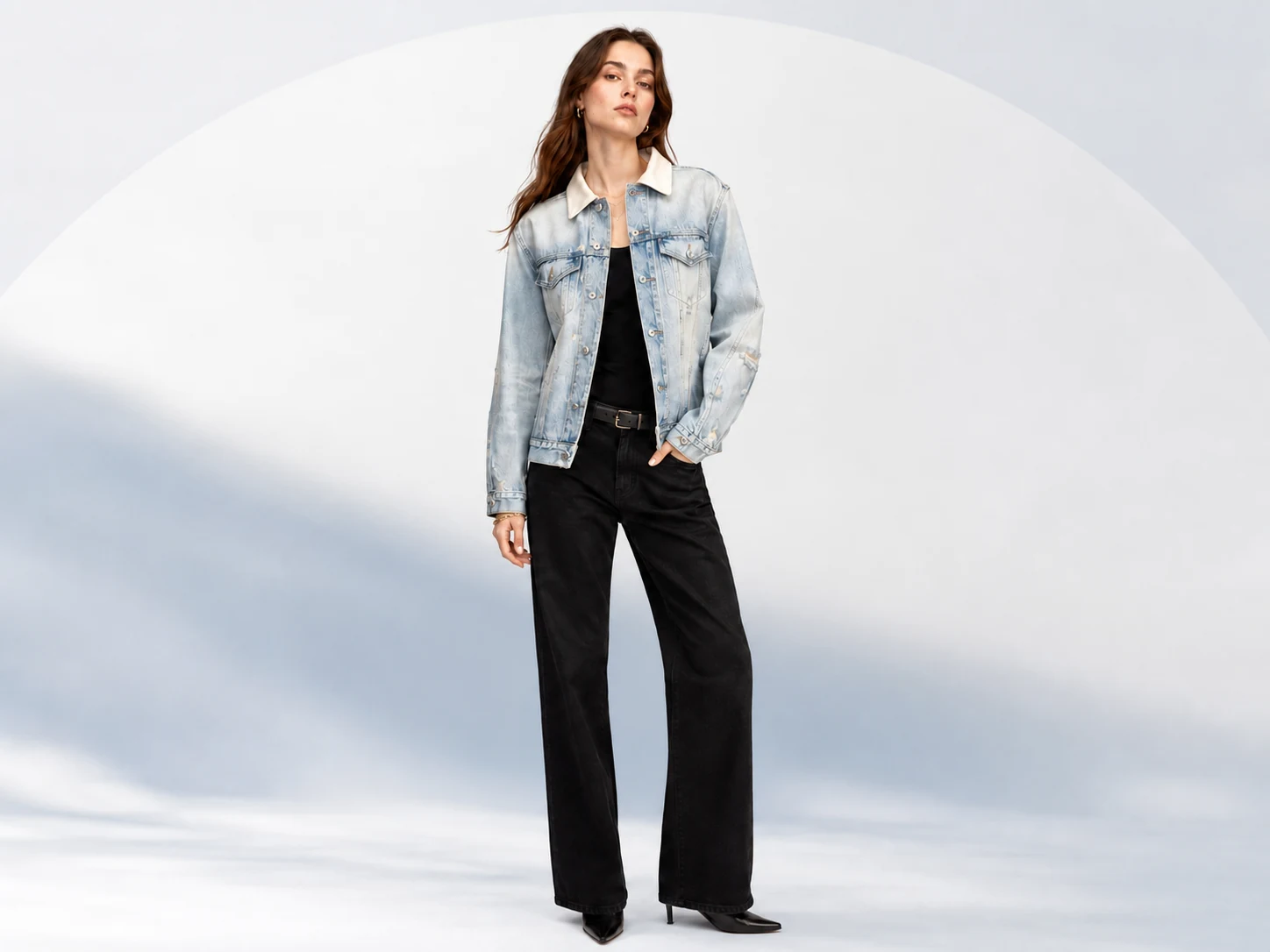 Female model wearing a light-wash custom denim jacket