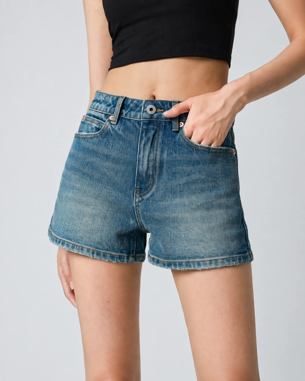 Women's classic mid-wash denim shorts with a high waist and straight leg