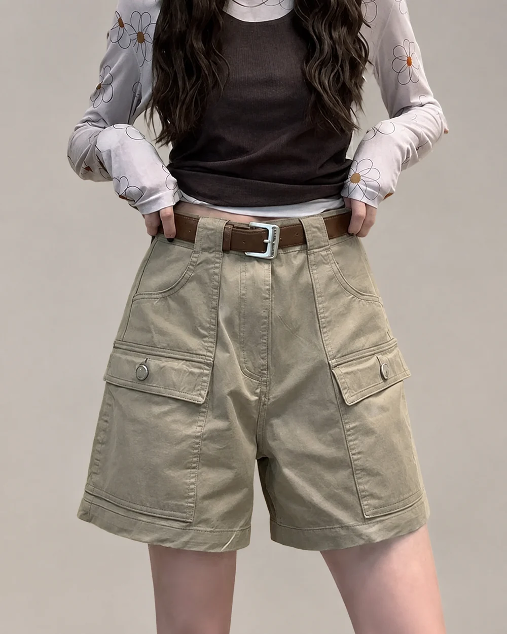 Women's khaki garment-dyed cargo shorts with flap pockets and a high waist