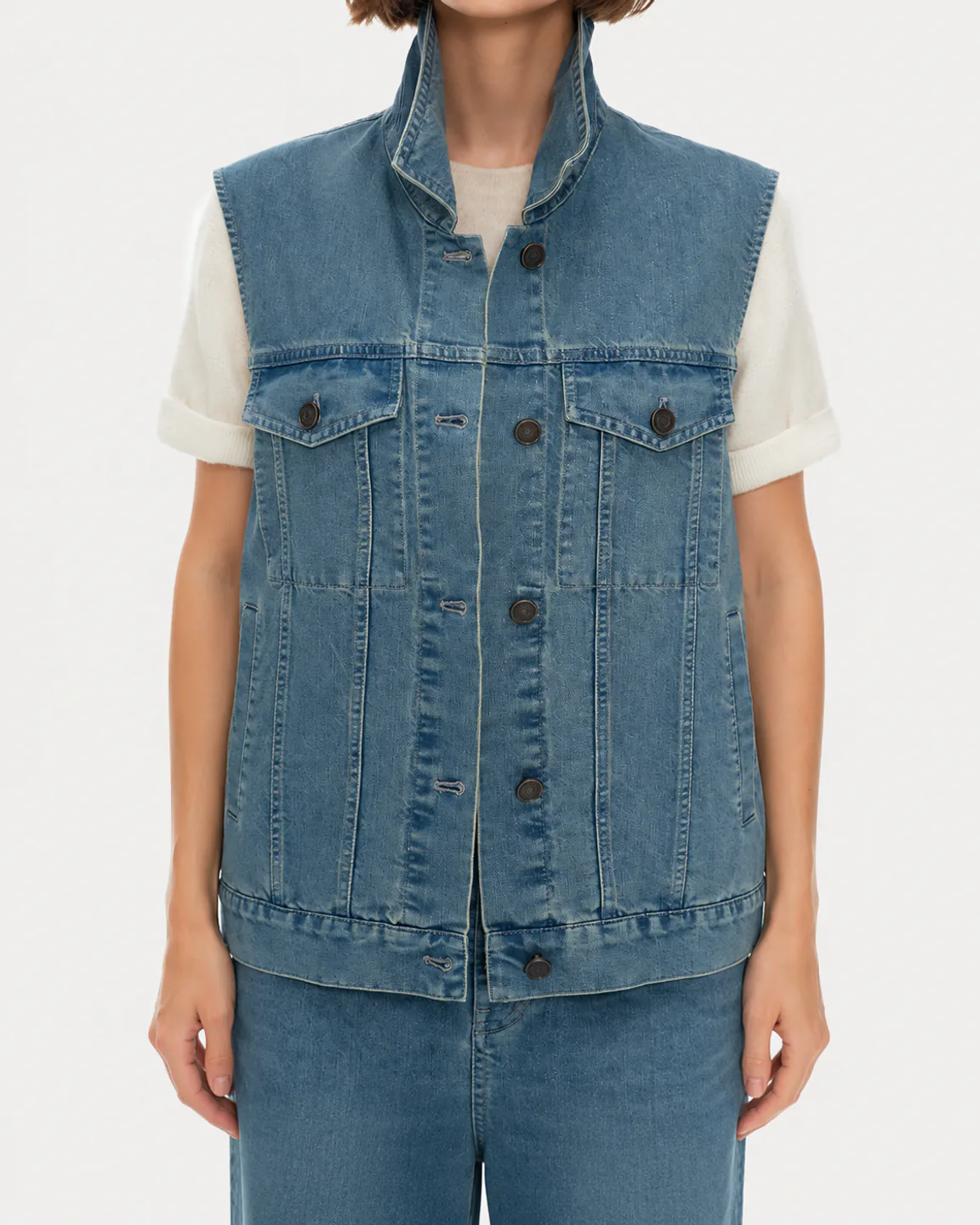 Women’s light-wash sleeveless denim vest with a stand collar and chest pockets