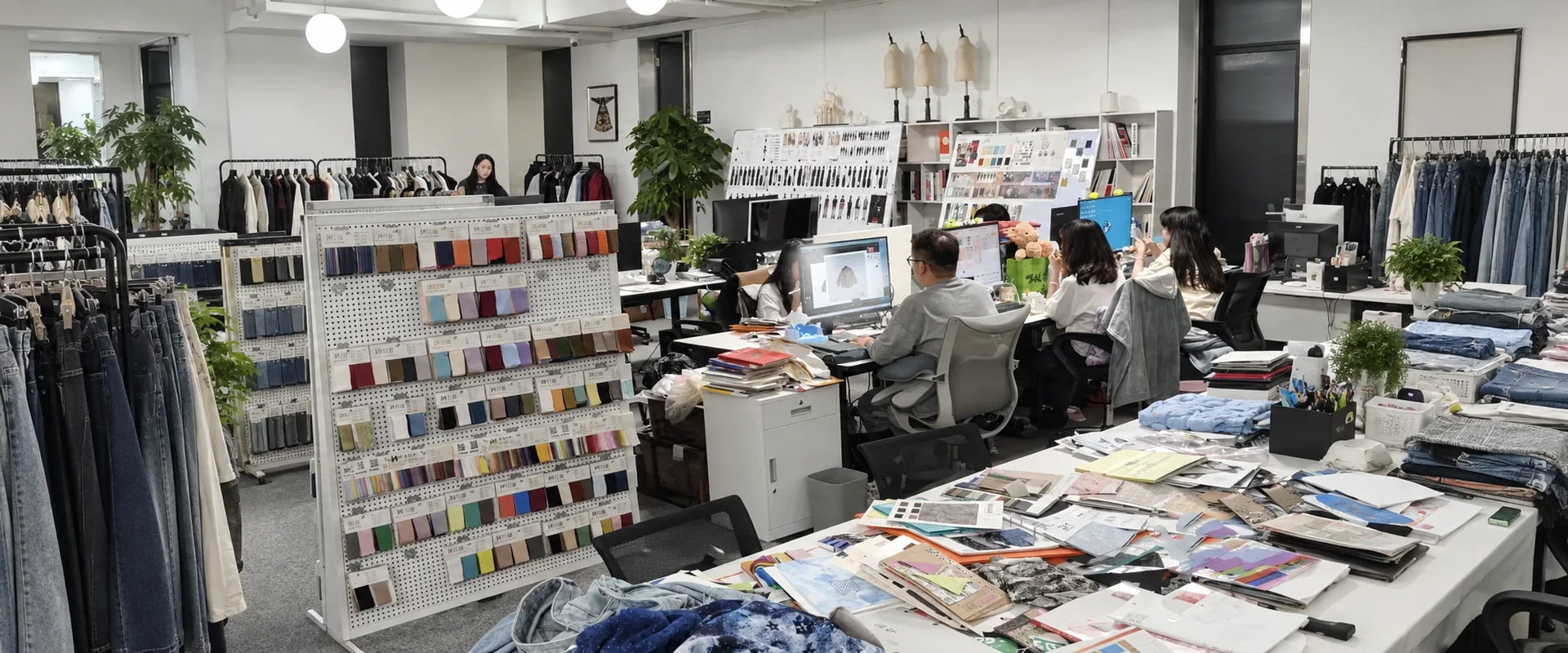 Beilin Denim merchandising team working with fabric swatches and denim samples in the office