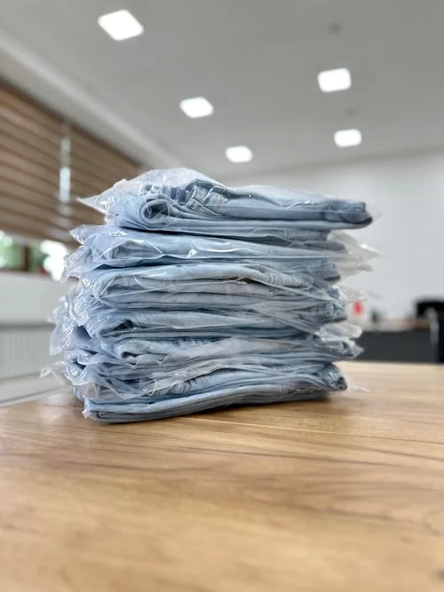 Finished denim garments stacked in protective packaging