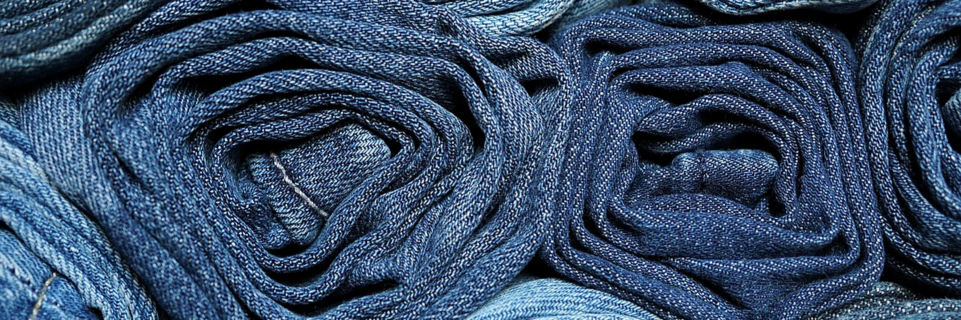 Rolled denim fabrics in different indigo shades for garment development