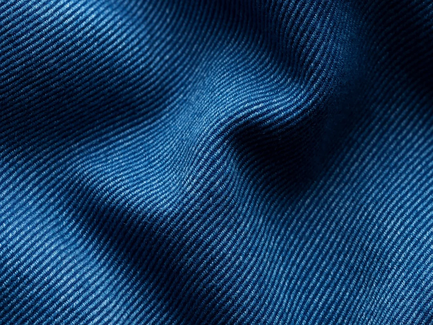 Close-up of indigo denim twill texture and fabric drape
